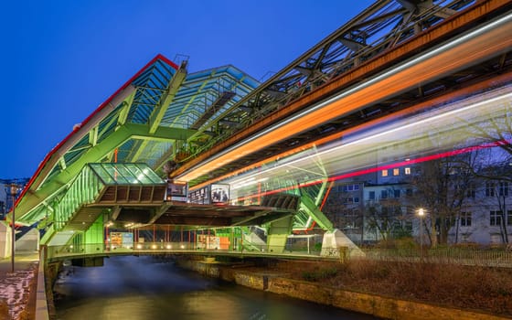 WUPPERTAL, GERMANY - JANUARY 21, 2023: Light trails around the suspension railway station Kluse in Wuppertal on January 21, 2023 in Bergisches Land, Germany