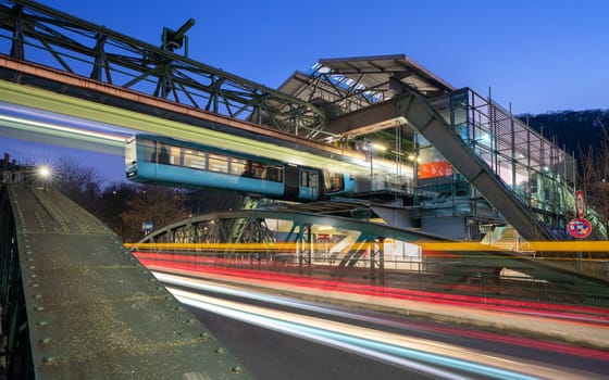 WUPPERTAL, GERMANY - JANUARY 28, 2023: Light trails around the suspension railway station Pestalozzi street in Wuppertal on January 28, 2023 in Bergisches Land, Germany