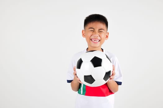 Portrait Asian smiling young boy kids holding a soccer ball studio shot isolated white background, cute child playing football sport hobby for kids, leisure games concept