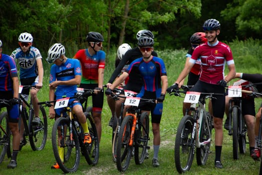 Kursk, Russia, June 15, 2024: Group of young cyclists preparing before the start of mountain biking competition