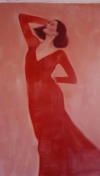 Woman in red dress standing in front of pink wall a vibrant portrait of fashion and beauty