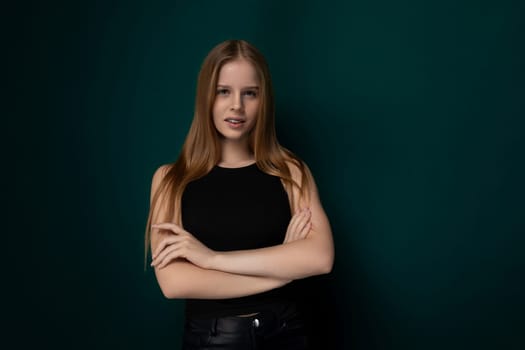 A woman with striking red hair stands confidently with her arms crossed. Her bold stance exudes strength and determination, emphasizing her independent nature.