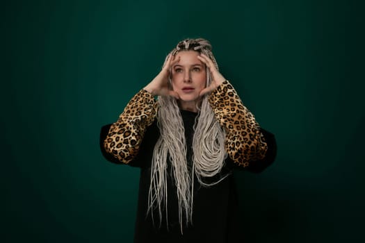A woman with long white hair is wearing a stylish leopard print jacket. She exudes confidence and fashion-forward style as she walks down the street.