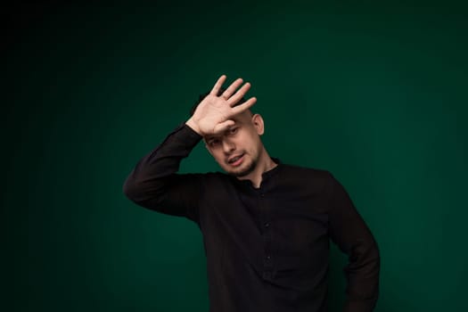 A man stands with his hands on his head, appearing distressed or frustrated. He seems to be deep in thought, possibly dealing with a difficult situation.