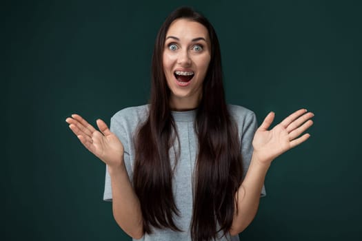 A woman with a surprised look on her face, her eyes wide and mouth slightly agape. She appears startled or amazed by something unexpected. Her eyebrows are raised, and her expression conveys shock or astonishment.