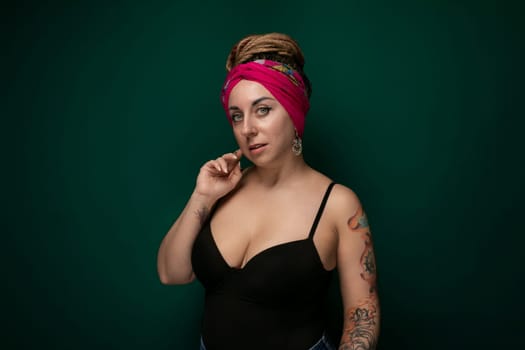 A woman wearing a pink headband is striking a pose for a photo. She looks directly at the camera with a smile, showing confidence and style in her posture.