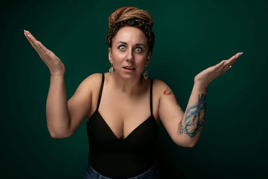 A woman wearing a black top is extending her hands outward in an open gesture.