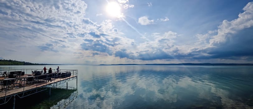 BALATON LAKE/HUNGARY - 2023-05-07 View on a Balaton lake. Great reflection of sky from wather surface.