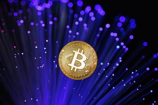 Glowing Bitcoin cryptocurrency against the background of fiber optic cables. Bitcoin digital cryptocurrency consisting of dots and lines, cryptocurrency mining. cryptocurrency exchange