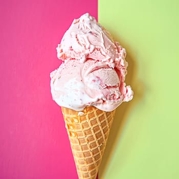 Scoops of ice cream in a waffle cone on a colorful background