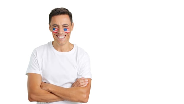 Man standing with United States flag painted on face smiling with arms crossed