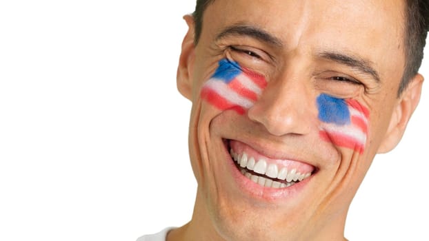 Close-up of a caucasian man with a USA flag painted on the face smiling at camera