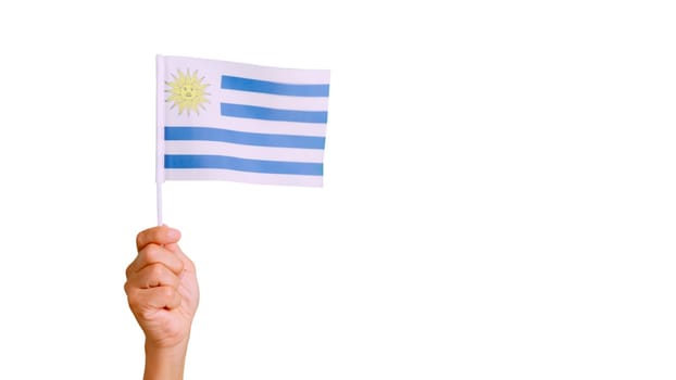 Photo of wind waving a uruguayan pennant holding by a hand. Slow Motion video