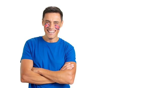 Man standing with british flag painted on face smiling with arms crossed