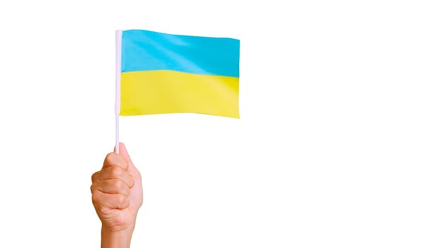 Photo of wind waving a ukrainian pennant holding by a hand