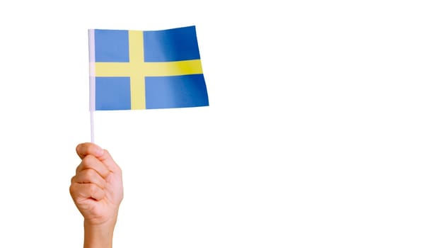 Photo of wind waving a swedish pennant holding by a hand