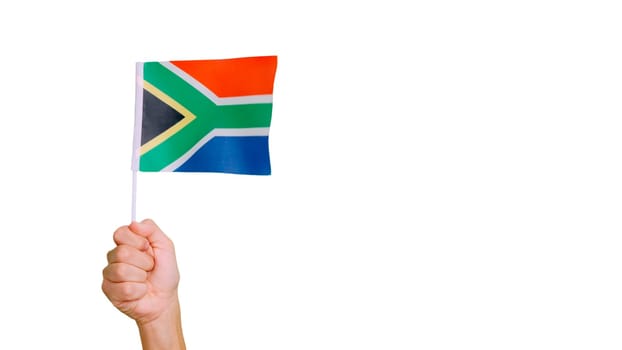 Photo of wind waving a south african pennant holding by a hand