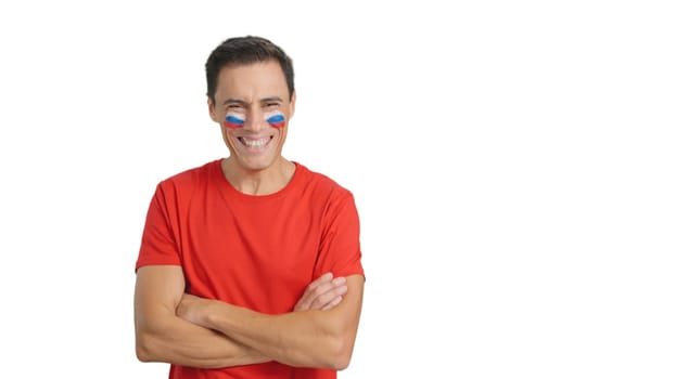 Man standing with russian flag painted on face smiling with arms crossed