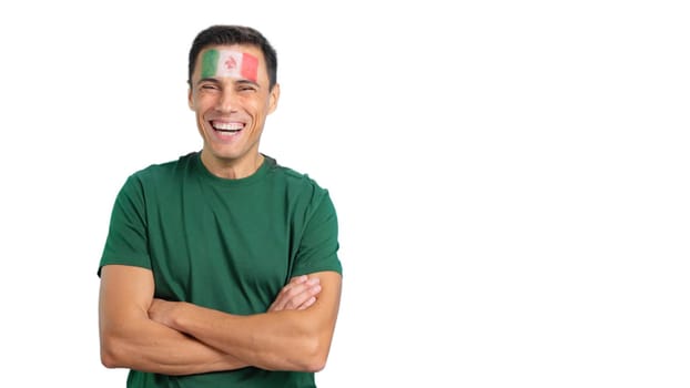 Man standing with mexican flag painted on face smiling with arms crossed
