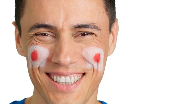 Close up of a man with a japanese flag painted on the face smiling at camera