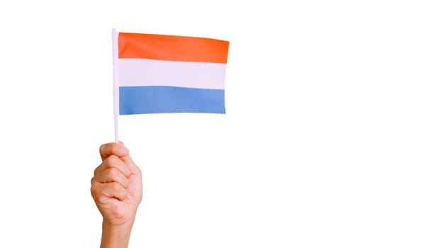 Photo of wind waving a dutch pennant holding by a hand