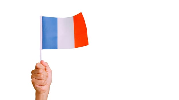 Photo of wind waving a french pennant holding by a hand