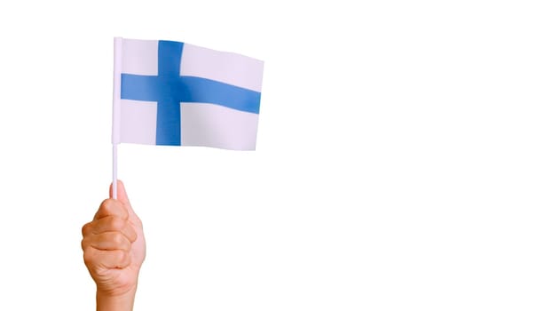 Photo of wind waving a finnish pennant holding by a hand.