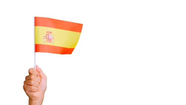 Photo of the wind waving a spanish pennant holding by a person
