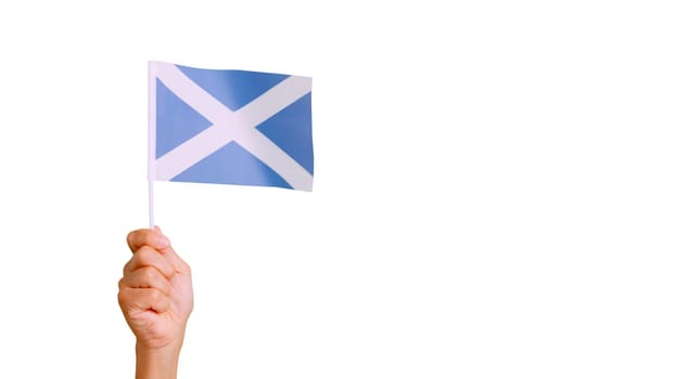 Photo of wind waving a scottish pennant holding by a hand.