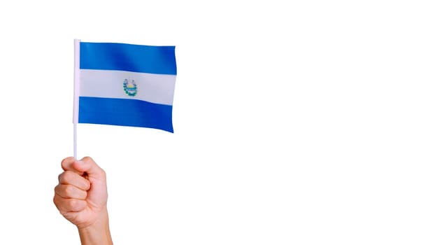 Photo of wind waving a salvadoran pennant holding by a hand.