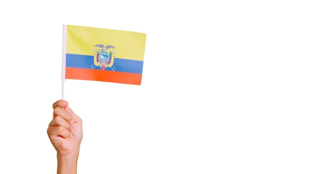 Photo of wind waving a ecuadorian pennant holding by a hand.