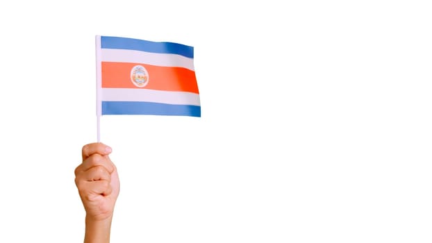 Photo of wind waving a costa rican pennant holding by a hand.