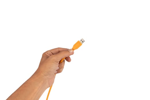 Male hand holding an orange usb cable isolated on white background. High quality photo