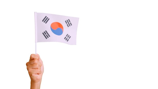 Photo of wind waving a south korean pennant holding by a hand.