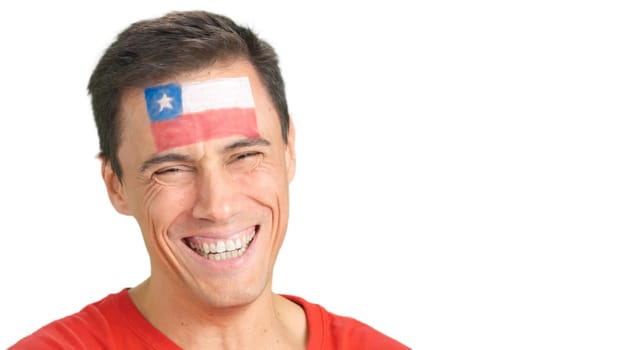Close up of a man with a chilean flag painted on the face smiling at camera