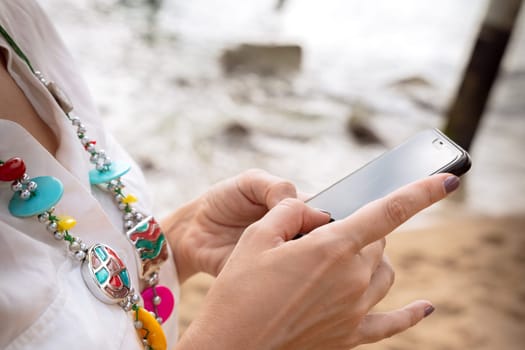 Woman hands typing on phone browsing telephone on social media.