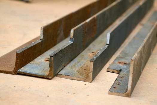 A steel angle is made by rolling a square steel billet