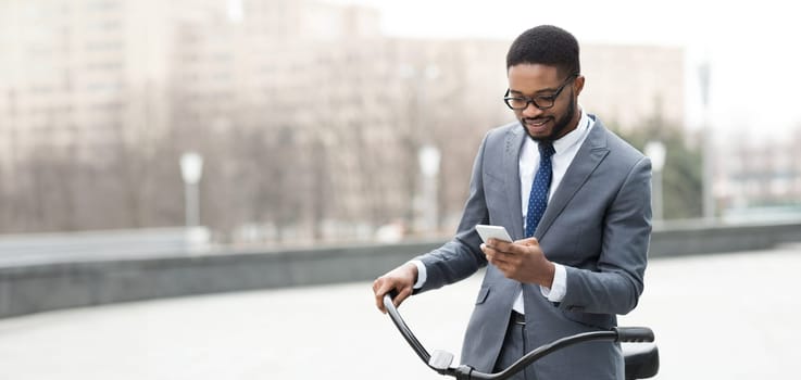 Black man is on his bike in the city, focused on his phone. The mood is dynamic and professional, reflecting the multitasking lifestyle of a modern urban professional.