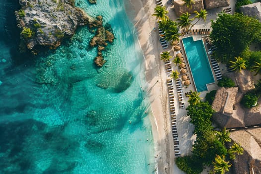 An aerial view of a tropical beach showing a swimming pool, coastal landforms, and lush greenery. The urban design includes houses and trees for leisure and relaxation