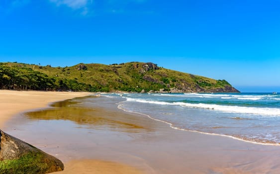 Image of Bonete beach on the island of Ilhabela with the hills and forest around it