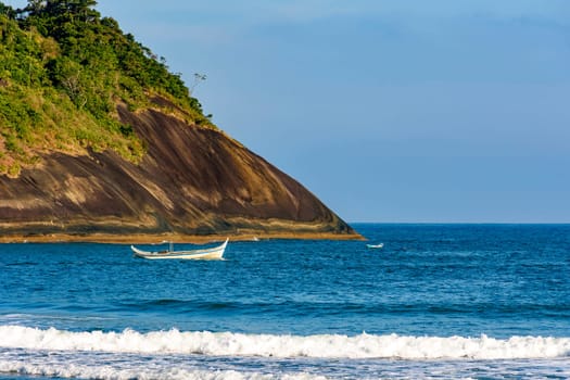 Old fshing boat on the sea at Bonete beach in Ilhabela