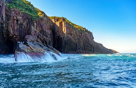 Cliff over the sea waters on the island of Ilhabela in Sao Paulo