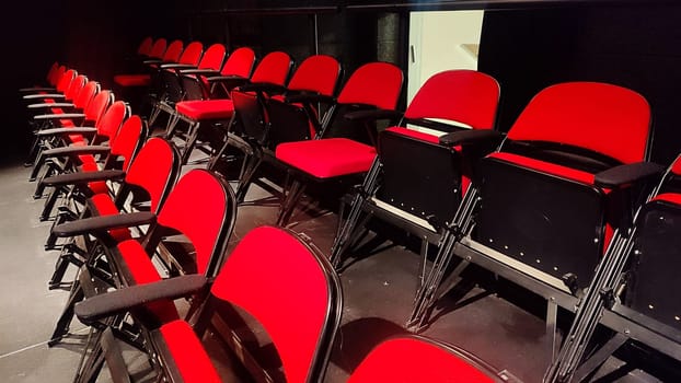red chairs in the theater, a row of objects. High quality photo
