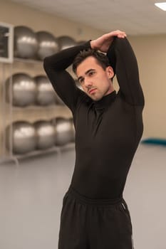 Caucasian man doing warm-up before exercise at a climbing wall