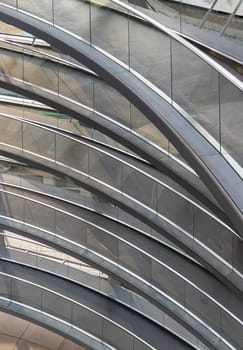 Berlin, Germany - Dec 20, 2023 - A curved walkway stretches in spirals upwards on top inside the glass dome constructed of the Reichstag building. Contemporary architecture of the Cupola of the Reichstag dome, a major tourist attraction of the berlin city, Copy space, Selective focus.
