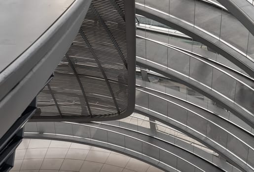 Berlin, Germany - Dec 20, 2023 - A curved walkway stretches in spirals upwards on top inside the glass dome constructed of the Reichstag building. Contemporary architecture of the Cupola of the Reichstag dome, a major tourist attraction of the berlin city, Space for text, Selective focus.