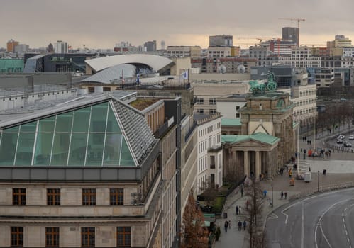 Berlin, Germany - Dec 20, 2023 - Berlin cityscape view with the Brandenburg Gate and the Eberstrasse from above of Reichstag building. a major tourist attraction of the berlin city, Copy space, Selective focus.