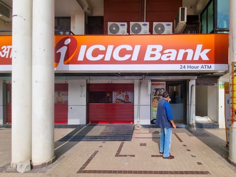 Jaipur, Rajasthan, India - 26th Nov 2023: Man standing looking at the empty ICICI bank office potential topic of shutdown, holiday and liquidity