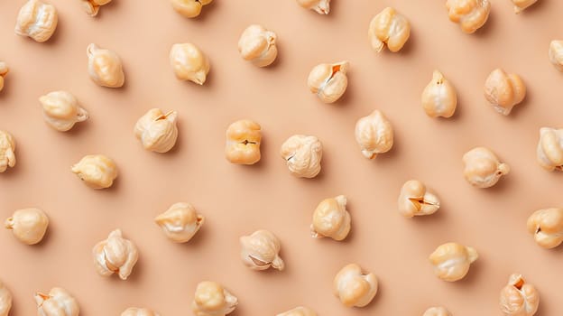Chickpeas arranged in a random pattern on beige background, top view. Healthy food concept.