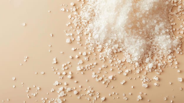 White sea salt crystals on a light brown surface, top view. Culinary and cooking ingredient concept.